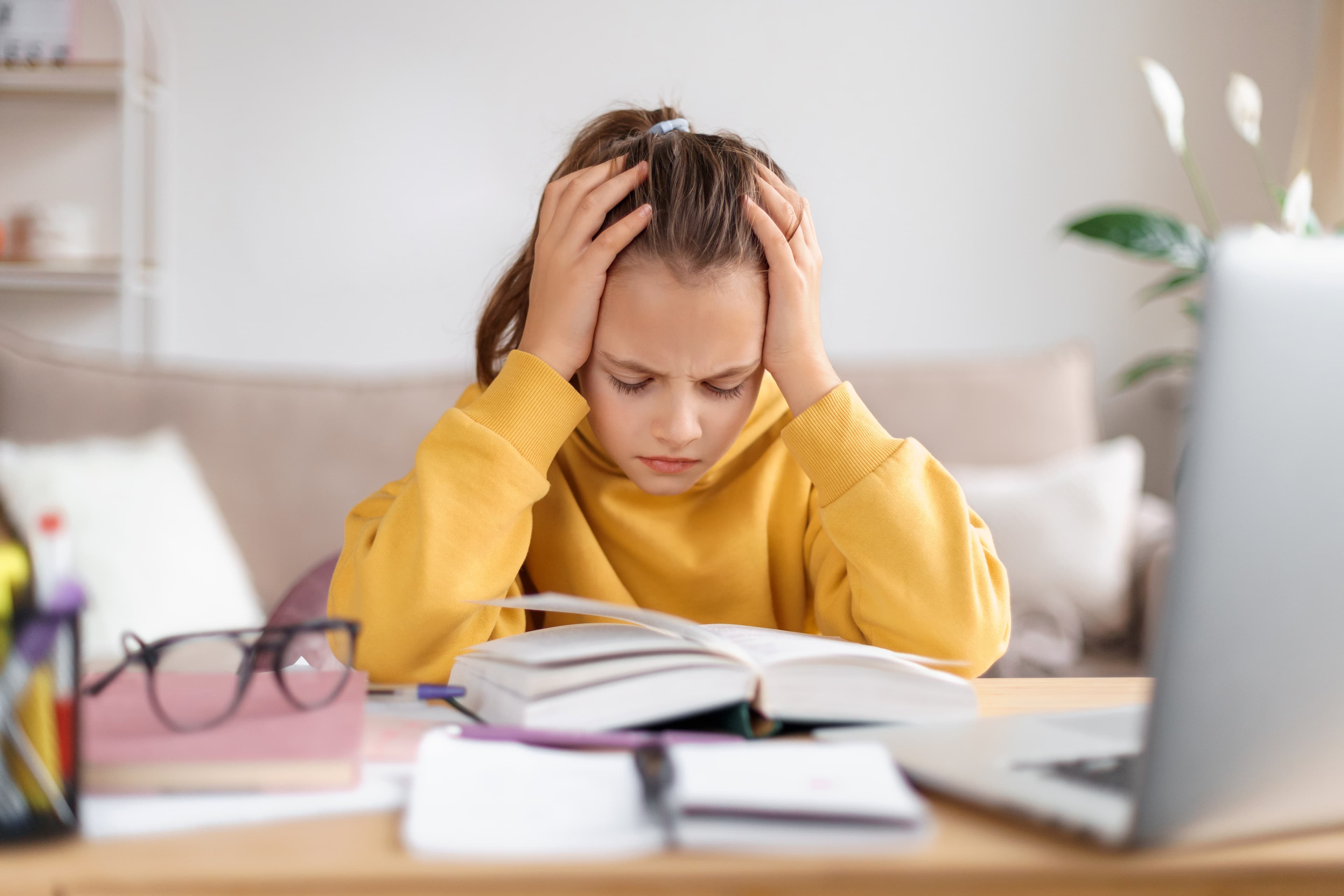 Frustrated student alone at table - The downward spiral of learning frustration